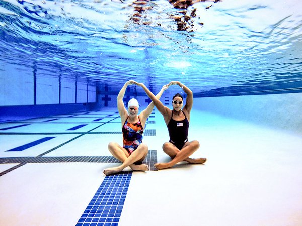 Female Elite Swimmers on bottom, clear water, queens, clean water, orenda pool, orenda enzymes, orenda water