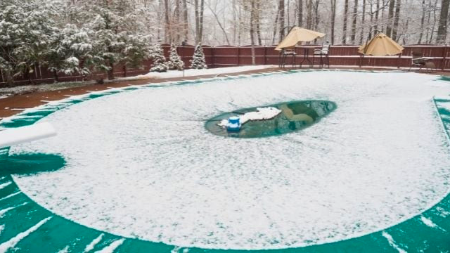 covered swimming pool covered in snow and ice - Edited